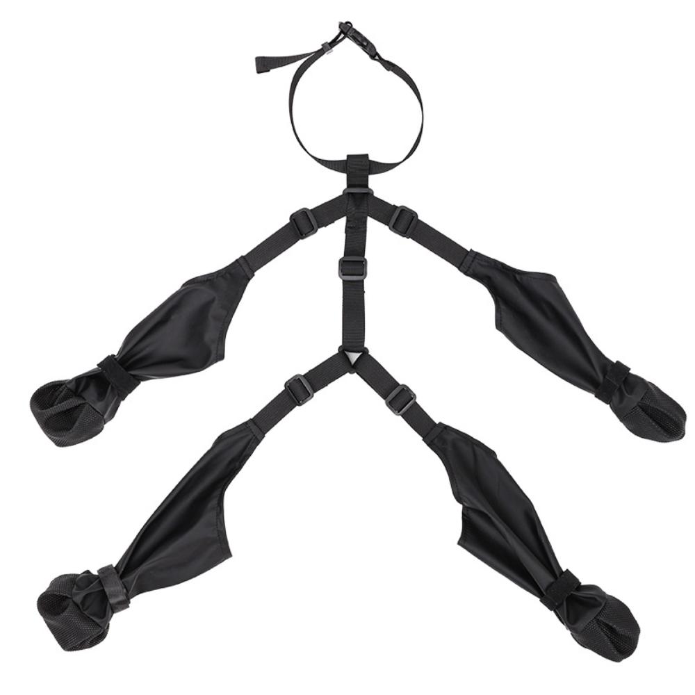 Black suspender dog boots laid out flat – four boot-leggings joined by adjustable straps and neck buckle