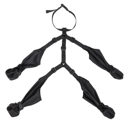 Black suspender dog boots laid out flat – four boot-leggings joined by adjustable straps and neck buckle