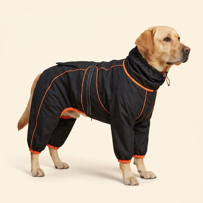 Breathable Water Resistant Dog Rain Jacket – Labrador wearing the black full-body rain suit with orange piping on a cream background