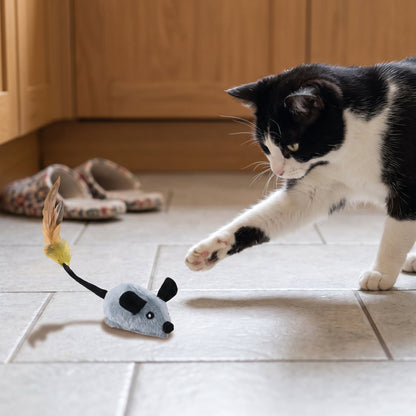 Interactive Pet Mouse Toy – cat swiping at the grey mouse on a tiled kitchen floor