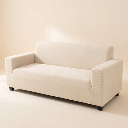 Pet Friendly Stretch Sofa Cover in beige white fitted on a three-seater sofa, studio photo on a cream background