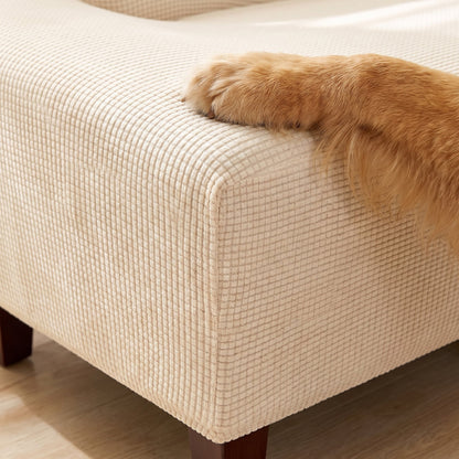 Close-up of the waffle knit texture of the beige white Pet Friendly Stretch Sofa Cover with a dog's paw
