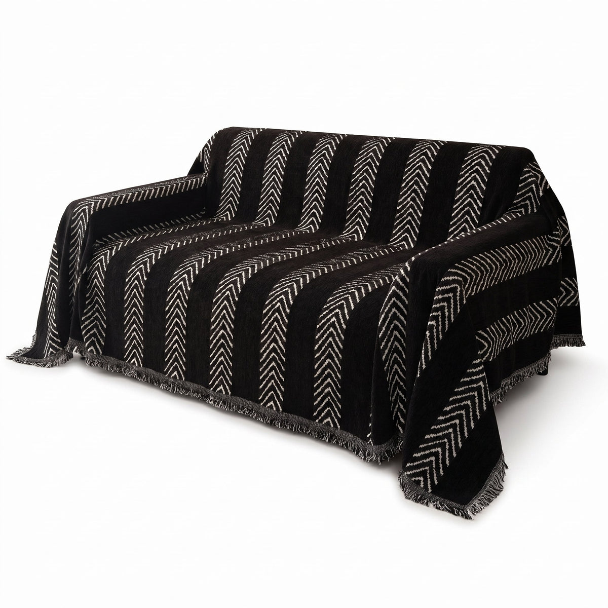 Large Monochrome Jacquard Sofa Blanket in black with white herringbone stripes on a sofa – product photo on white background
