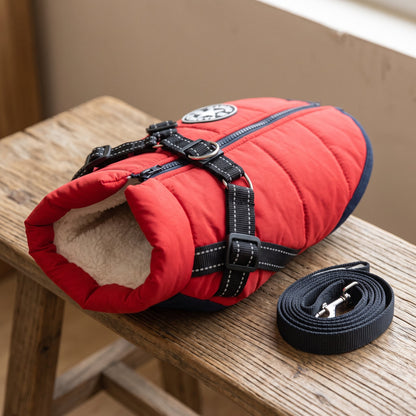 Rainproof pet coat with built-in harness in red, folded to show the quilted stitching, fluffy collar lining and D-ring