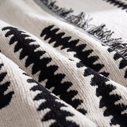 Close-up of the soft chenille weave and fringed edge of the sofa cover