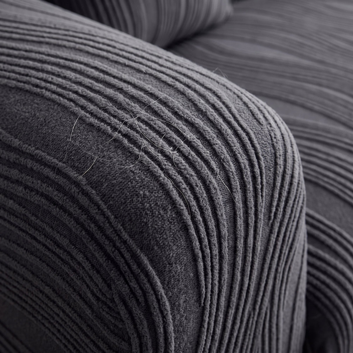Close-up of the raised wavy-rib jacquard knit texture of the stretch pet sofa cover